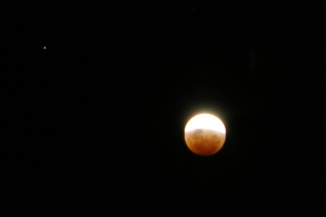 Early into a total lunar eclipse, 20 February 2008, with Saturn up and to the left. Photographed with a Pentax *ist DL2 dSLR.